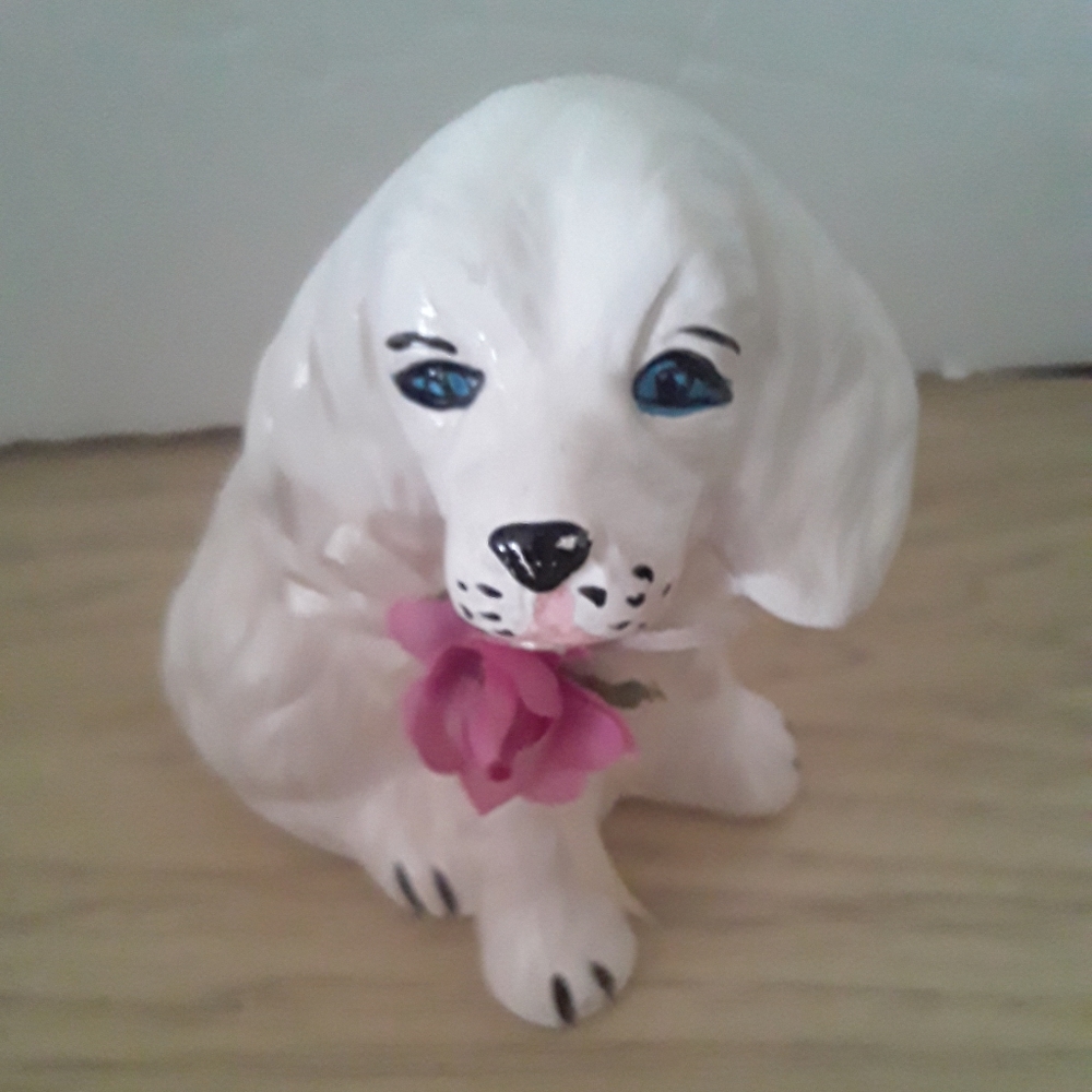 White Ceramic dog with blue eyes and flowrr